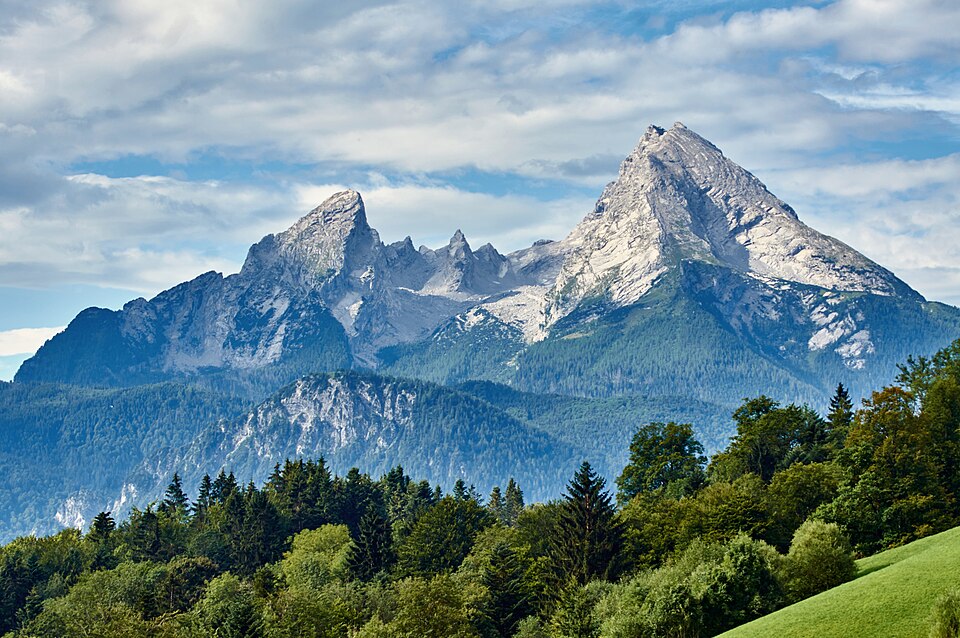 The rocky twin summits and children of the Watzmann massif rising above dark green forested slopes.